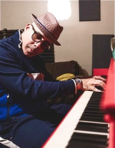 Sam Barsh at piano creating music for brand licensing, featured in Soundstripe’s royalty-free library.