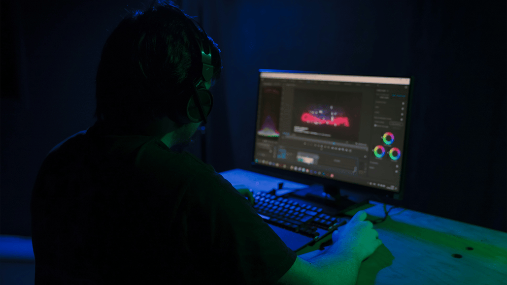 A content creator works in his edit suite using a lossless audio format, the best audio format for video editing