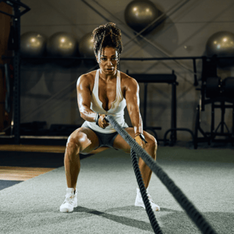 Strong woman working out with ropes