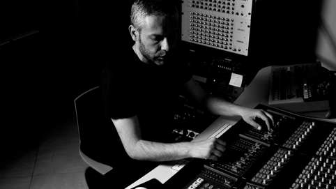 Person operating soundboard to create content for a synchronization license