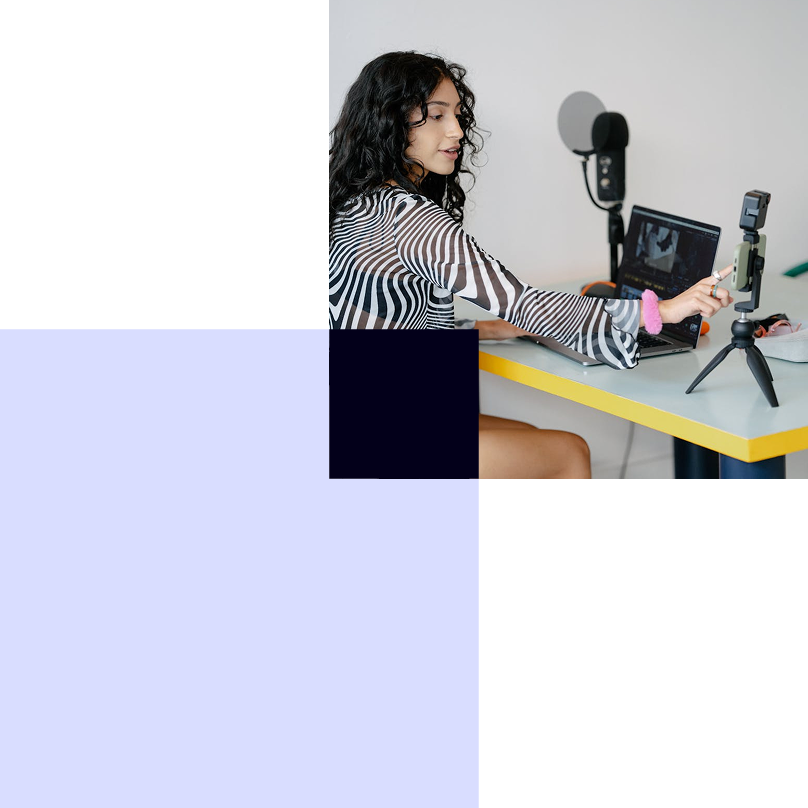 Woman with laptop selecting royalty free music for her podcasts and business.