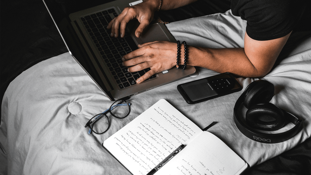 A movie producer uses a cue sheet template to carefully fill out a cue sheet for film on his laptop computer.